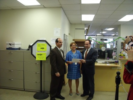 Joe Ganim hands exploratory committee filing to Town Clerk Alma Maya. At left Ganim's brother Ray committee treasurer.